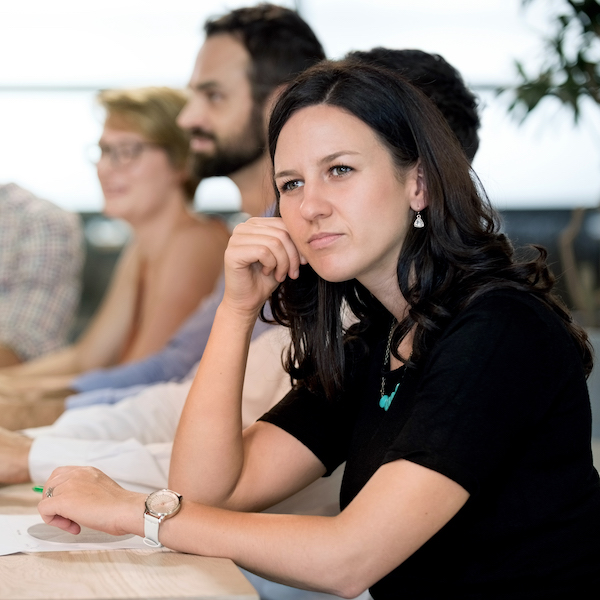 A veteran sits in a seminar and looks as though her thoughts are miles away, as though she is thinking deeply about an abstract idea